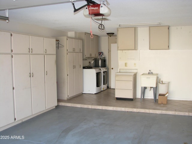 garage with independent washer and dryer, water heater, a sink, and a garage door opener