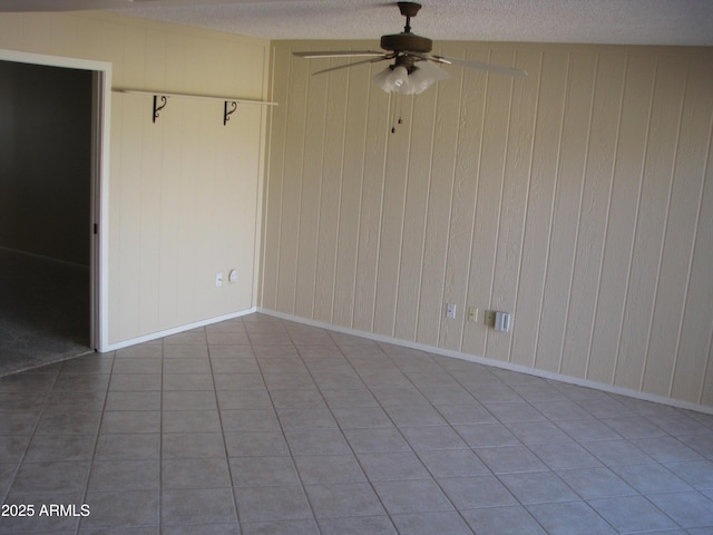 unfurnished room with ceiling fan, a textured ceiling, and baseboards