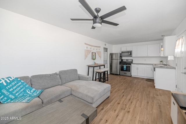 715 W Cinnabar Ave, Phoenix, AZ 85021 - living room with light wood-style flooring and ceiling fan