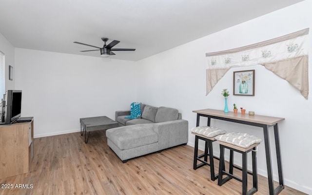 715 W Cinnabar Ave, Phoenix, AZ 85021 - living area featuring light wood-style floors, baseboards, and ceiling fan