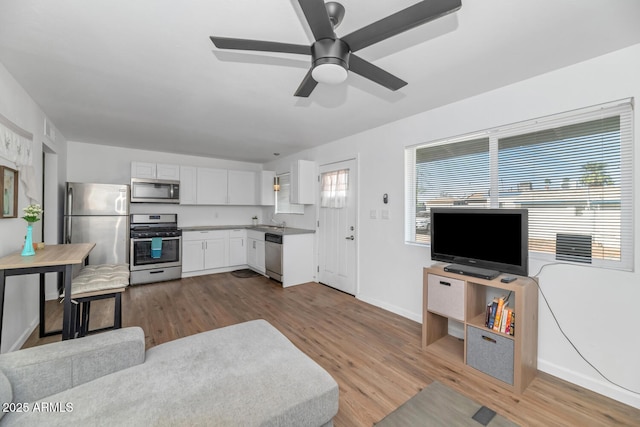 715 W Cinnabar Ave, Phoenix, AZ 85021 - living room featuring dark wood-type flooring, baseboards, and ceiling fan