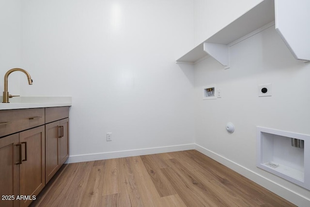 laundry area with light wood-style flooring, hookup for an electric dryer, washer hookup, and baseboards