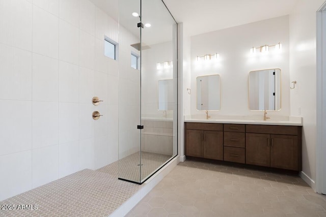 bathroom with a sink, double vanity, recessed lighting, tile patterned flooring, and tiled shower