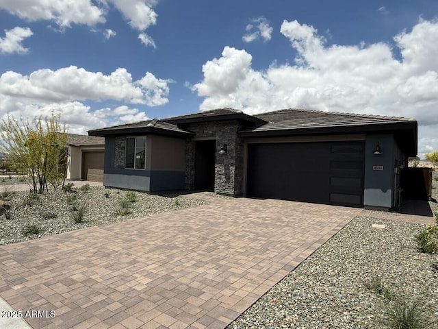 4556 Painted Wagon Way, Wickenburg, AZ 85390 - prairie-style home featuring a garage, decorative driveway, stucco siding, stone siding, and a tile roof