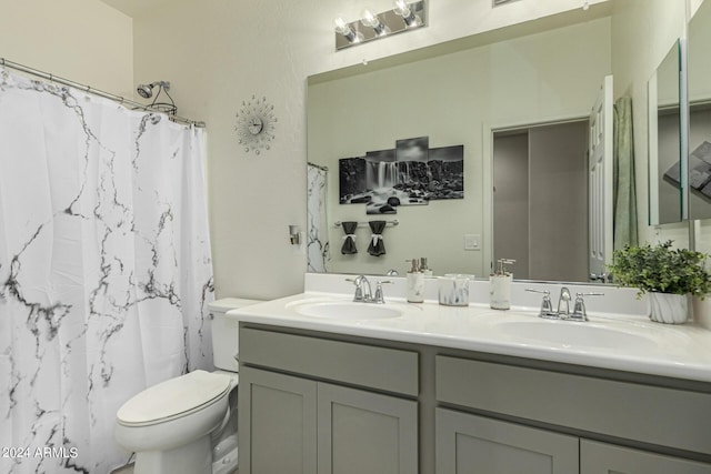 bathroom featuring vanity, a shower with shower curtain, and toilet