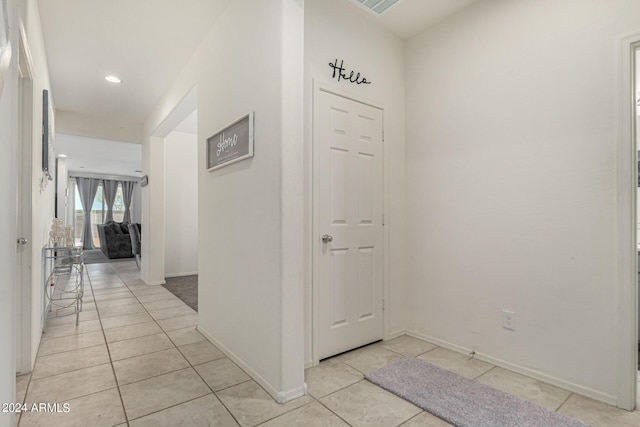 hallway featuring light tile patterned floors