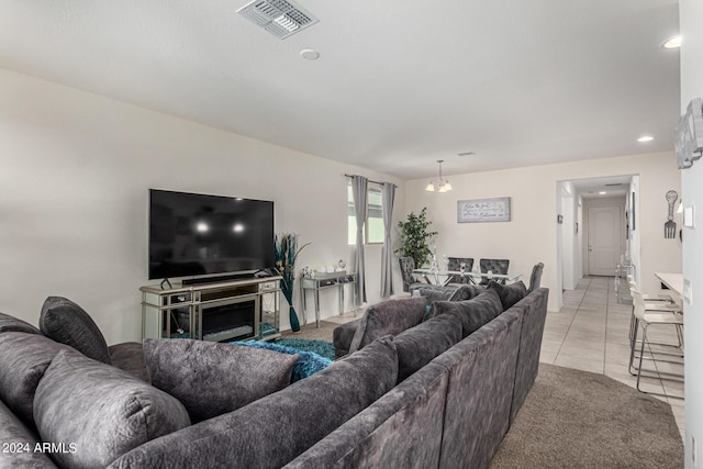 living room with a chandelier and light tile patterned flooring