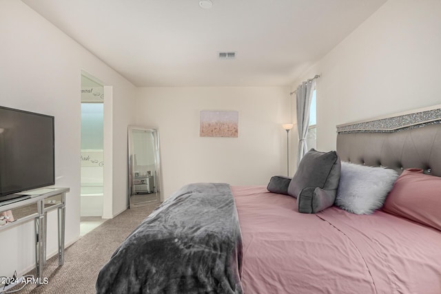 carpeted bedroom featuring connected bathroom