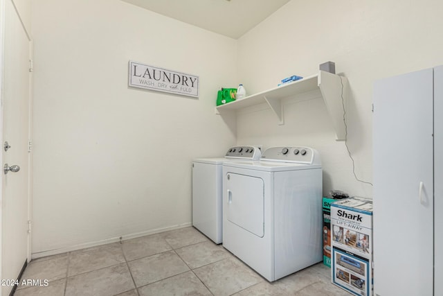 laundry room with washer and dryer and light tile patterned flooring