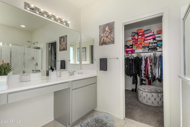 bathroom featuring vanity and an enclosed shower