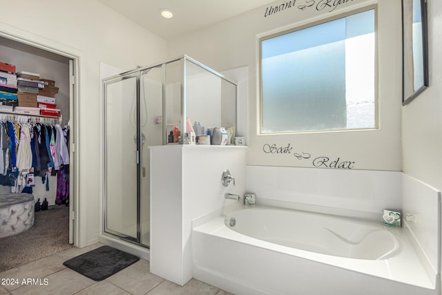 bathroom featuring tile patterned flooring and shower with separate bathtub