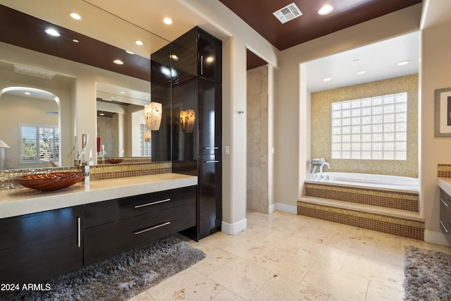 bathroom with recessed lighting, visible vents, a bath, and vanity