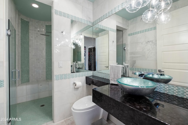 bathroom featuring vanity, an enclosed shower, tile patterned flooring, tile walls, and toilet