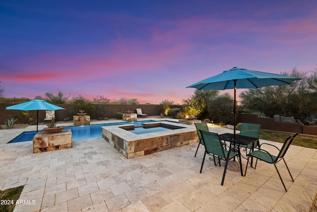 view of swimming pool featuring outdoor dining area, fence, an in ground hot tub, and a patio area