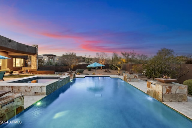 view of pool featuring a pool with connected hot tub, a patio, and fence