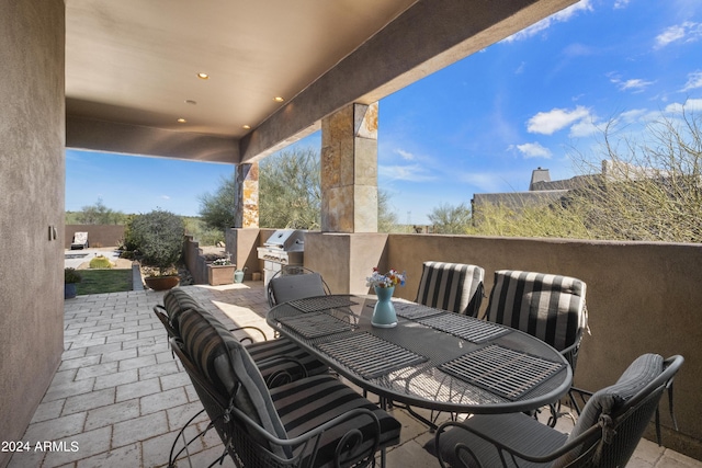 view of patio / terrace featuring area for grilling and outdoor dining area