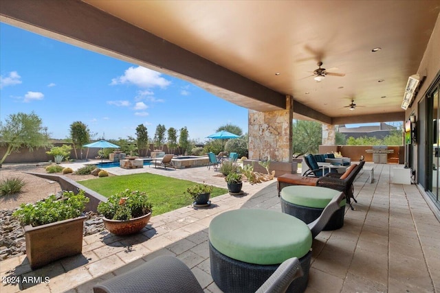 view of patio / terrace with outdoor lounge area, a swimming pool, and ceiling fan