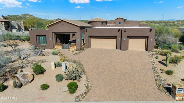 pueblo revival-style home with a garage