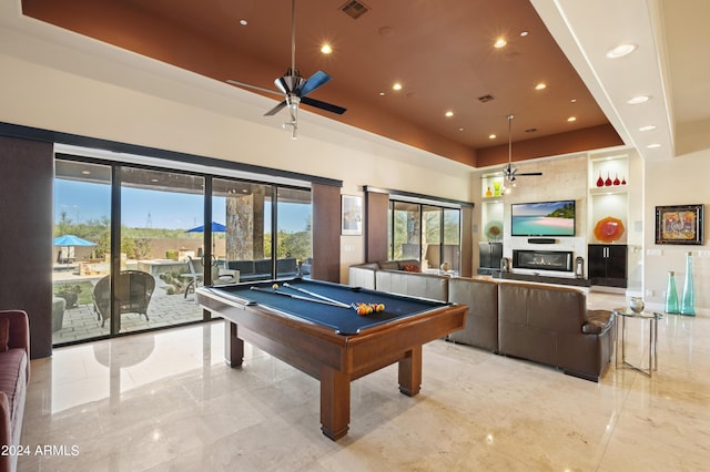 playroom featuring visible vents, built in shelves, billiards, a raised ceiling, and a tile fireplace