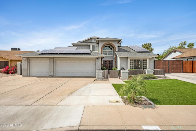 5020 E Dallas St, Mesa, AZ 85205 - traditional-style home with a gate, roof mounted solar panels, concrete driveway, an attached garage, and stucco siding