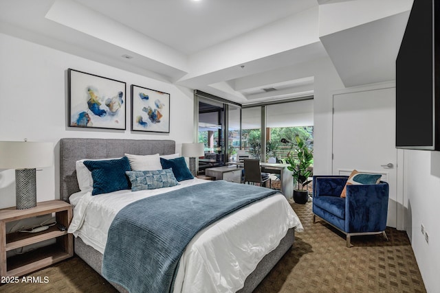 bedroom with visible vents and a tray ceiling