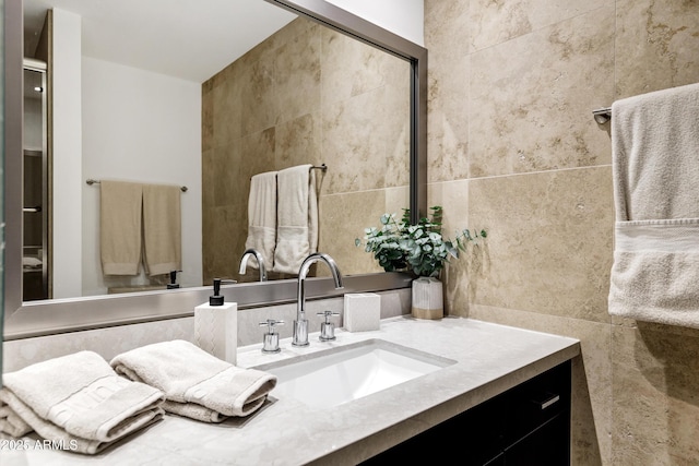 bathroom with tile walls and vanity