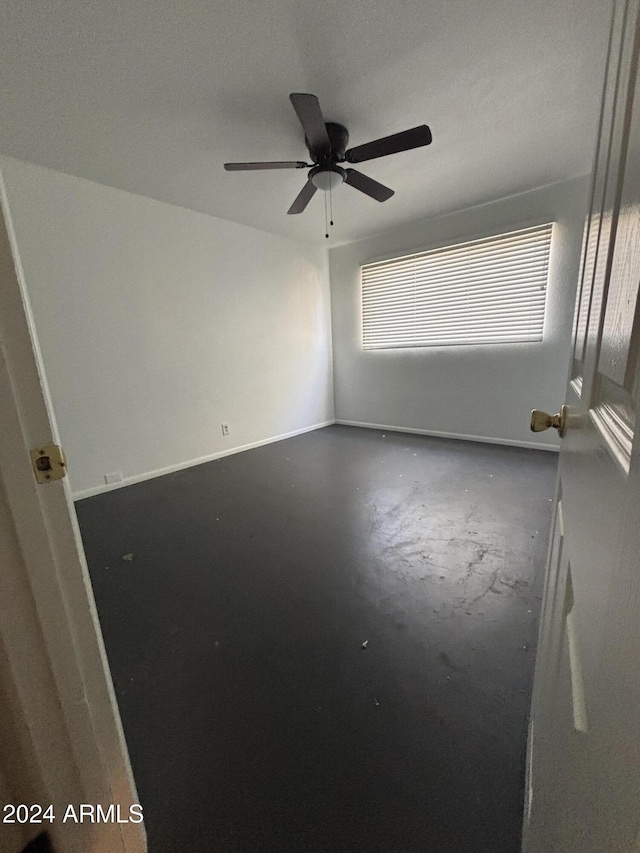 spare room with ceiling fan, concrete floors, and a textured ceiling