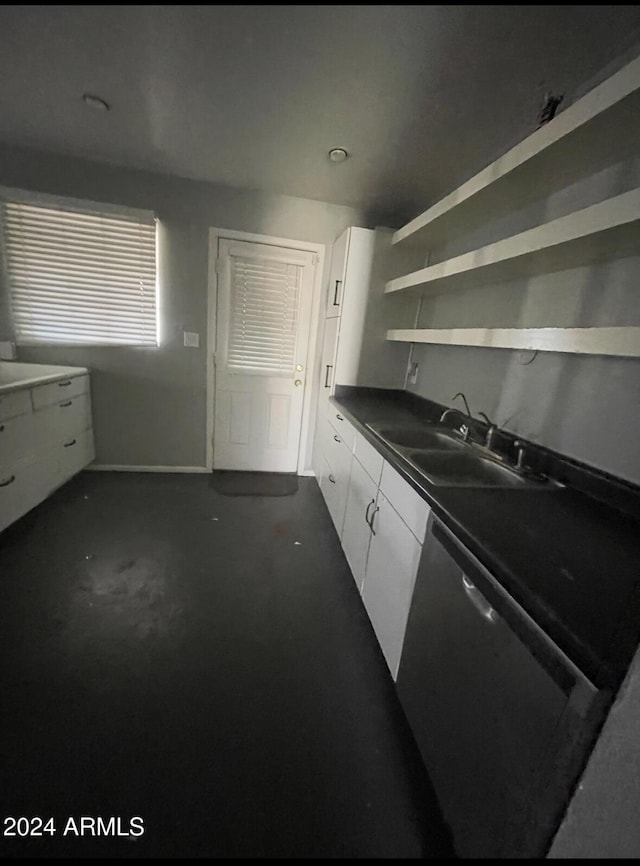 kitchen featuring dishwasher, white cabinetry, and sink