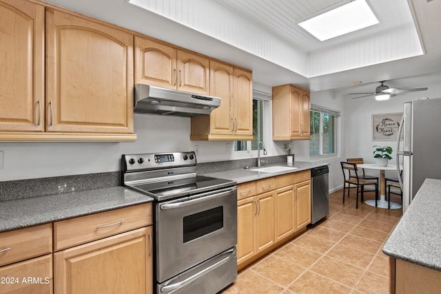 kitchen featuring appliances with stainless steel finishes, sink, light tile patterned floors, ceiling fan, and light brown cabinets