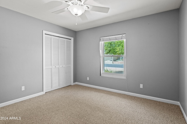 unfurnished bedroom featuring ceiling fan, carpet floors, and a closet