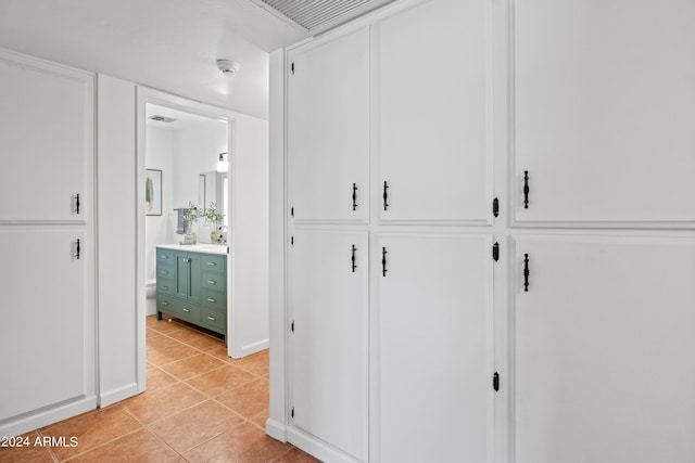 corridor featuring light tile patterned floors