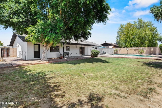 view of yard with a fenced in pool and a patio