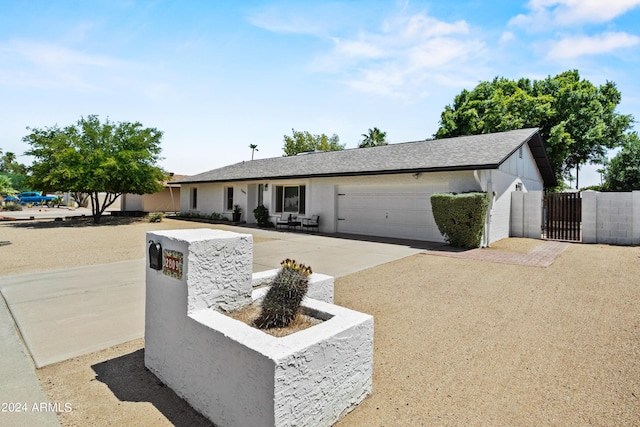 ranch-style house with a garage and a patio area