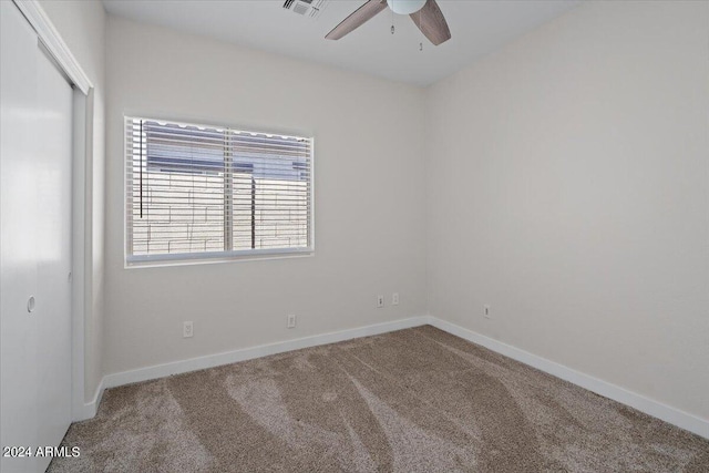 carpeted empty room with ceiling fan