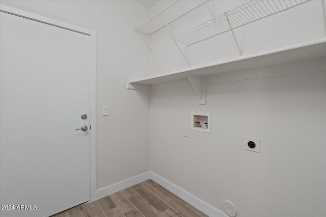 washroom with hookup for a gas dryer, hookup for a washing machine, wood-type flooring, and hookup for an electric dryer