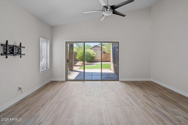 spare room featuring ceiling fan, light hardwood / wood-style flooring, and vaulted ceiling