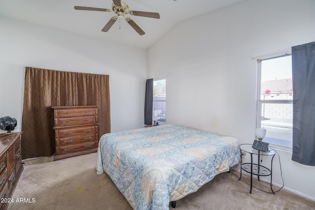 carpeted bedroom with ceiling fan and vaulted ceiling