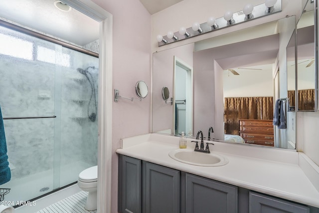 bathroom with walk in shower, tile patterned flooring, vanity, and toilet