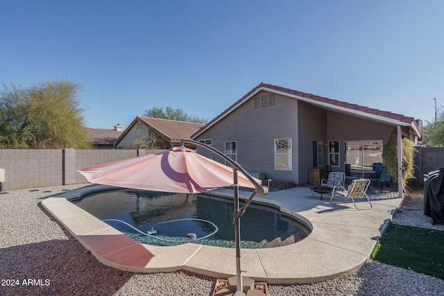 view of pool featuring an outdoor fire pit and a patio