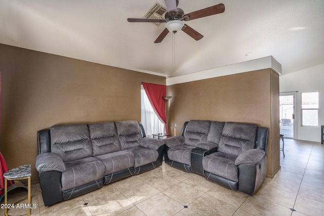 tiled living room featuring ceiling fan and vaulted ceiling