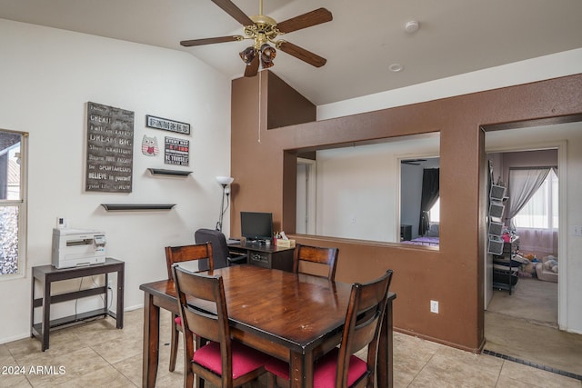 tiled dining area with ceiling fan and vaulted ceiling