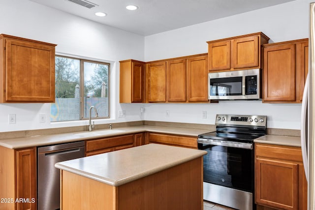 kitchen with stainless steel appliances, a center island, and sink