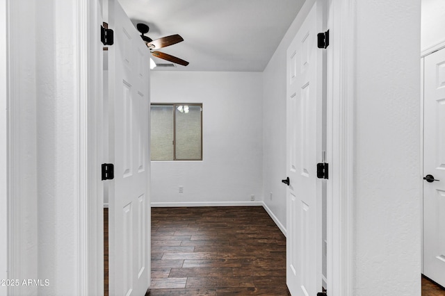 unfurnished bedroom featuring ceiling fan and dark hardwood / wood-style flooring