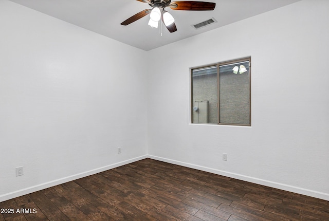 spare room with dark wood-type flooring and ceiling fan