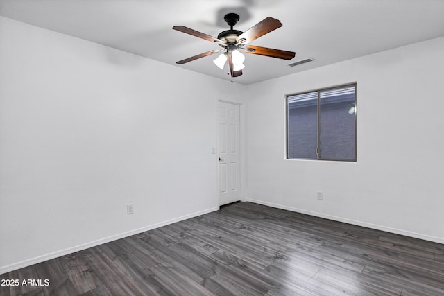 unfurnished room featuring dark hardwood / wood-style floors and ceiling fan