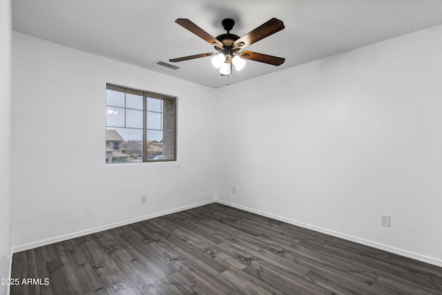 empty room with ceiling fan and dark hardwood / wood-style flooring