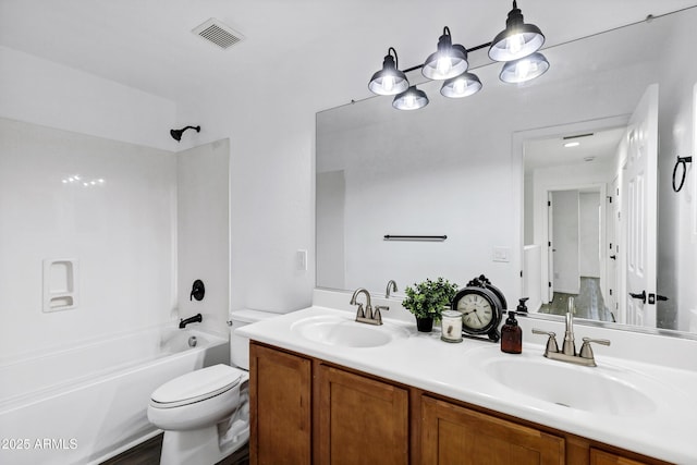 full bathroom featuring vanity, tub / shower combination, and toilet