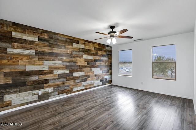 spare room featuring ceiling fan and dark hardwood / wood-style floors