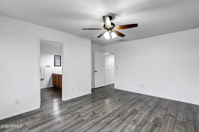 unfurnished bedroom featuring dark wood-type flooring, ceiling fan, and ensuite bathroom