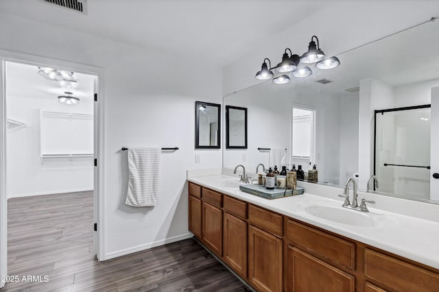 bathroom featuring a shower with door, vanity, and hardwood / wood-style floors